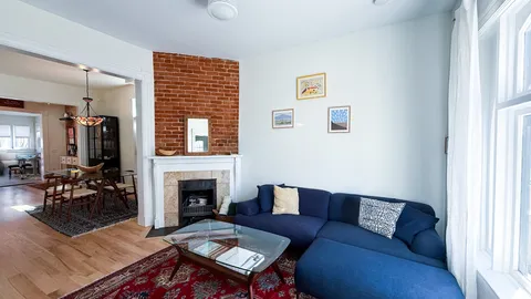 a living room with furniture fireplace and window