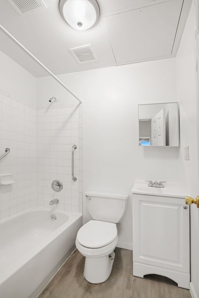 1978 Madison Avenue, Unit 5 Manhattan, NY 10035 - Photo 7 of 10 a bathroom with a toilet a sink and bathtub