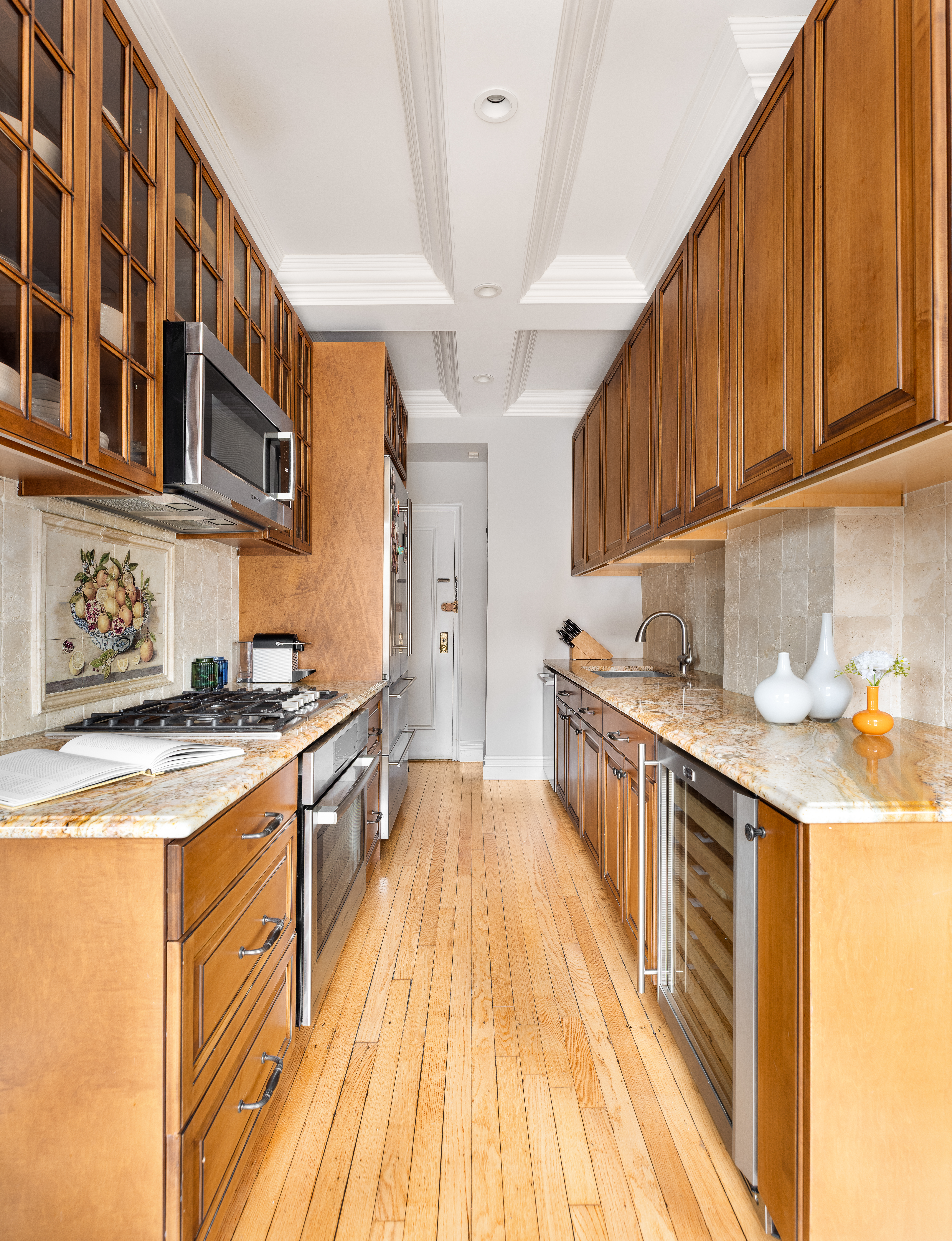 55 Park Avenue, Unit 9E Manhattan, NY 10016 - Photo 8 of 9 a kitchen with stainless steel appliances granite countertop a stove and a sink