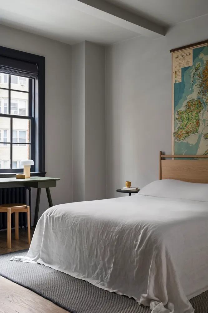 a bedroom with a bed and a window