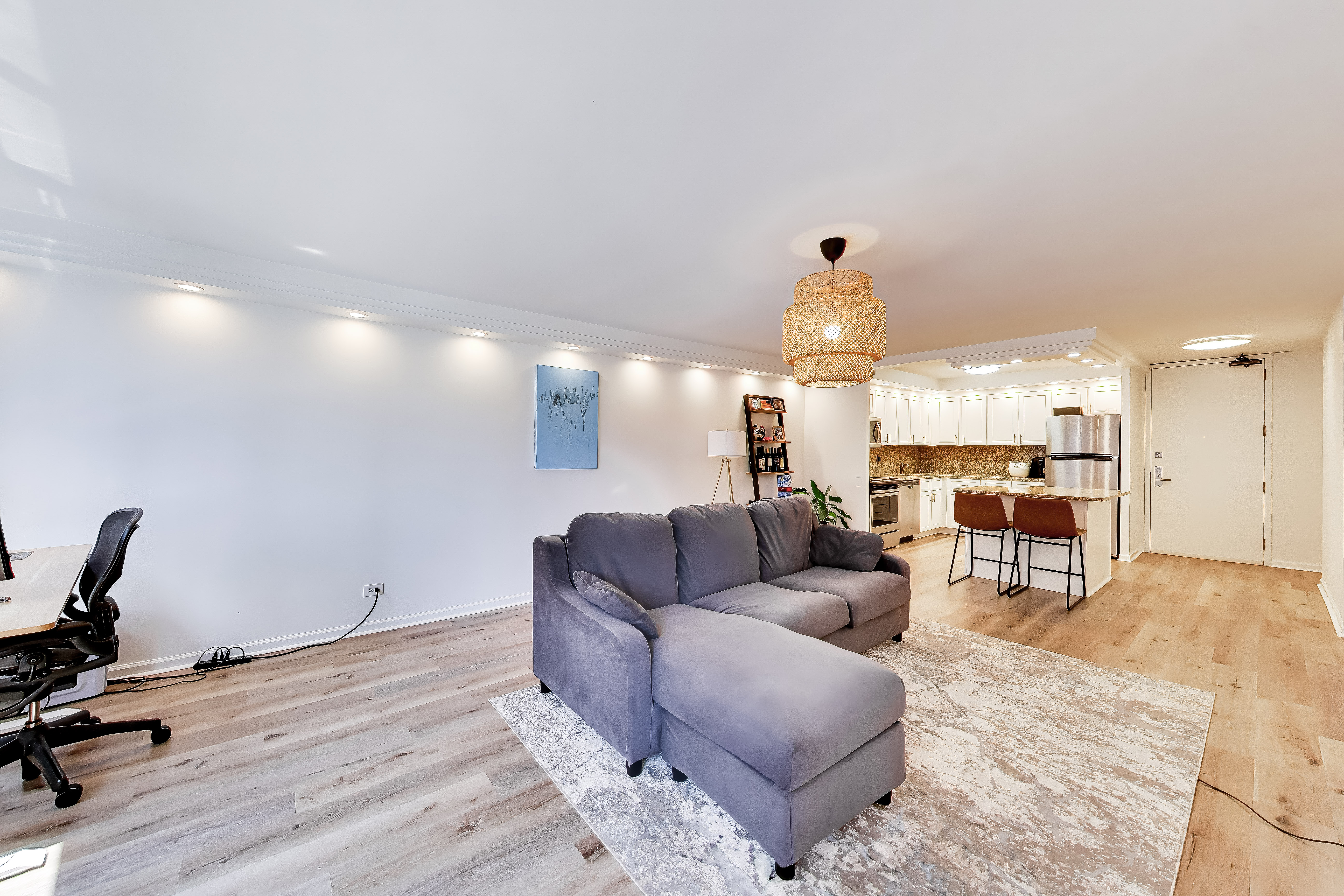 110 East Delaware Place, Unit 1402 Chicago, IL 60611 - Photo 12 of 23 a living room with furniture and a wooden floor