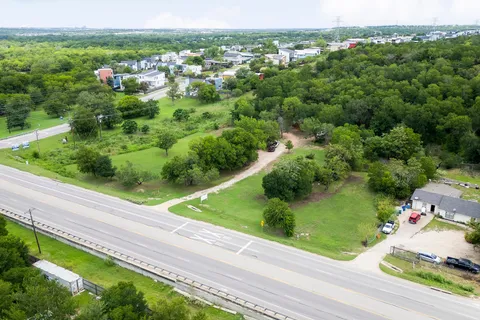 an aerial view of a houses with yard