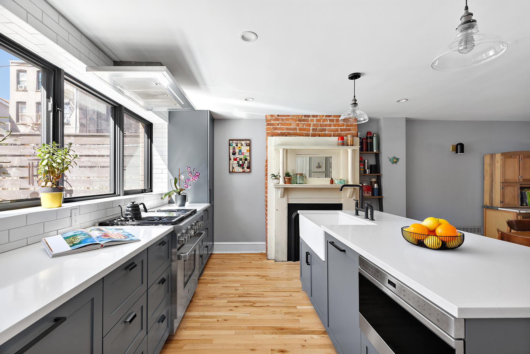 232 Monroe Street Brooklyn, NY 11216 - Photo 5 of 21 a large kitchen with stainless steel appliances a lot of counter space and wooden floor
