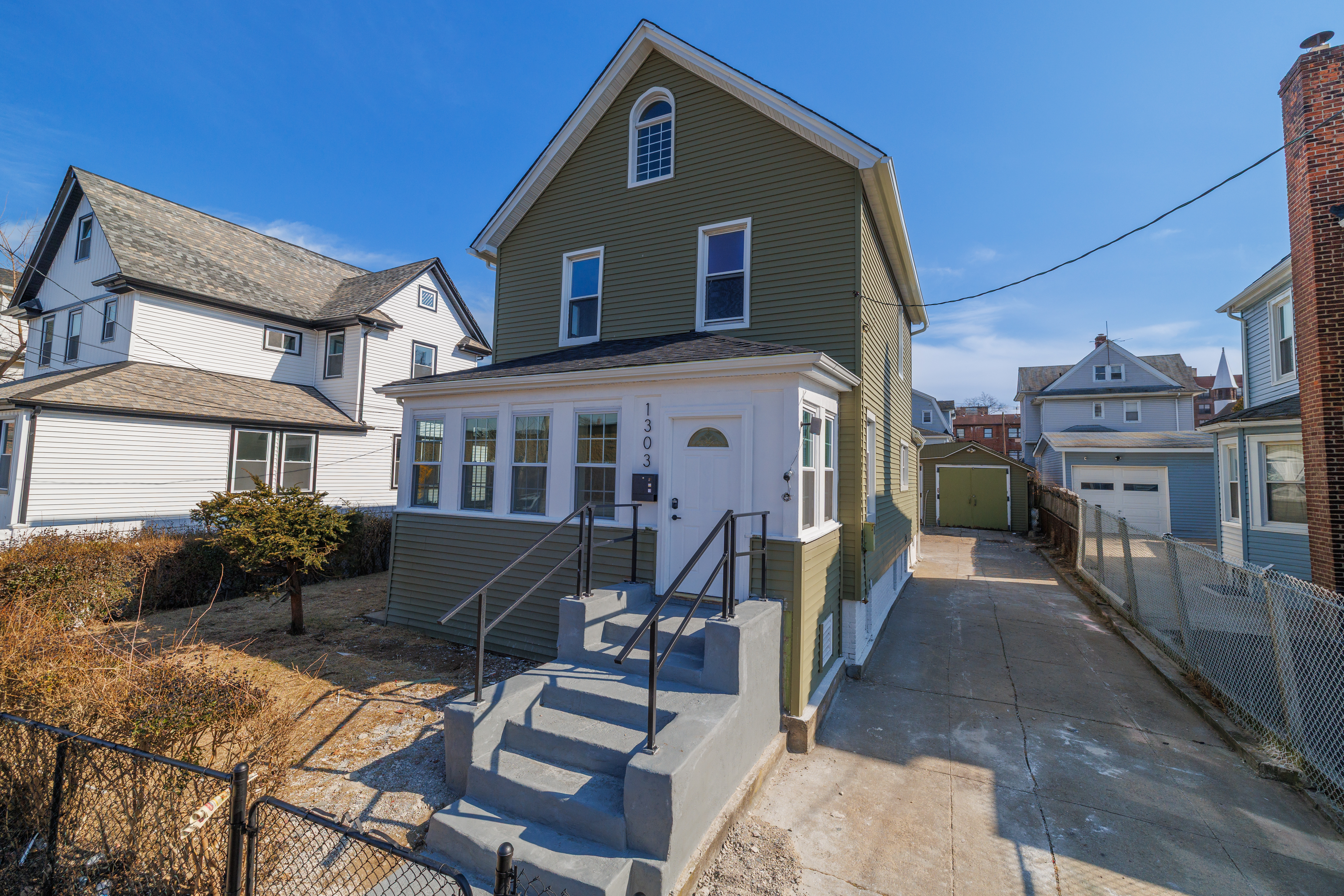 13-03 Brunswick Avenue Queens, NY 11691 - Photo 2 of 27 a front view of a house with yard and furniture