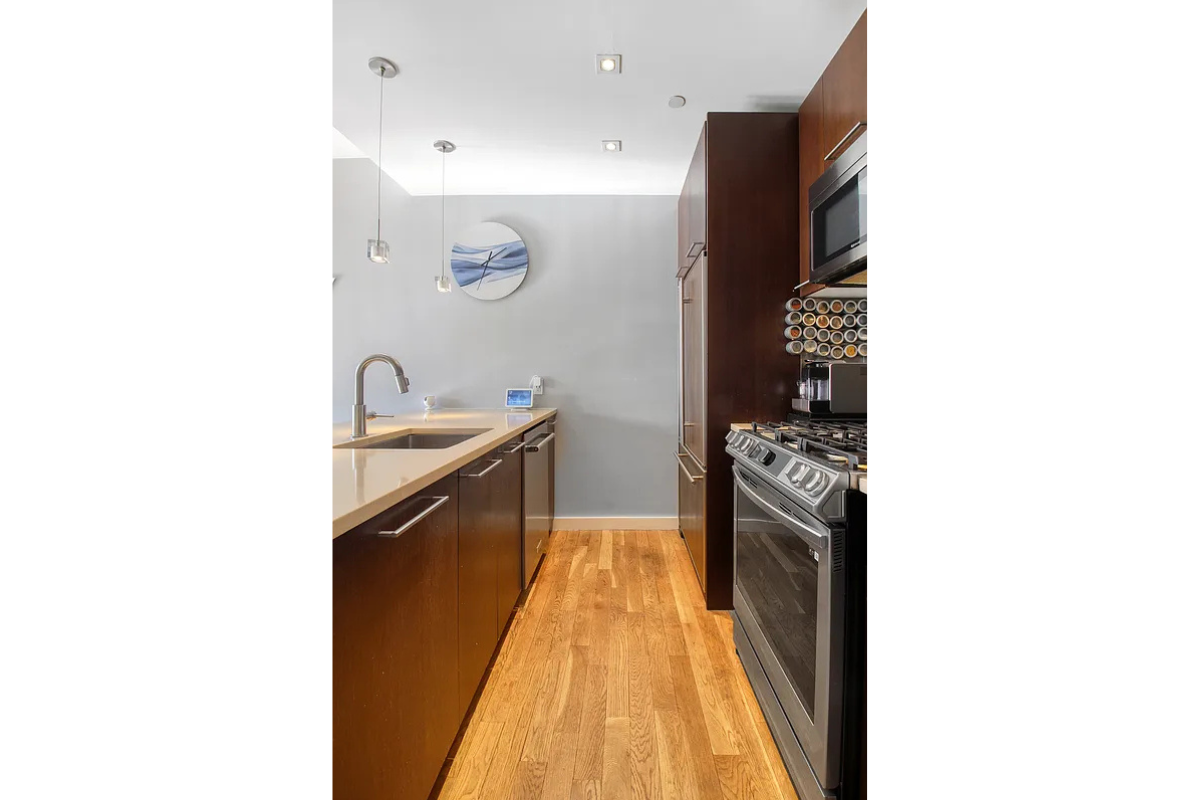342 East 110th Street, Unit 5E Manhattan, NY 10029 - Photo 7 of 23 a kitchen with stainless steel appliances granite countertop a sink and a refrigerator