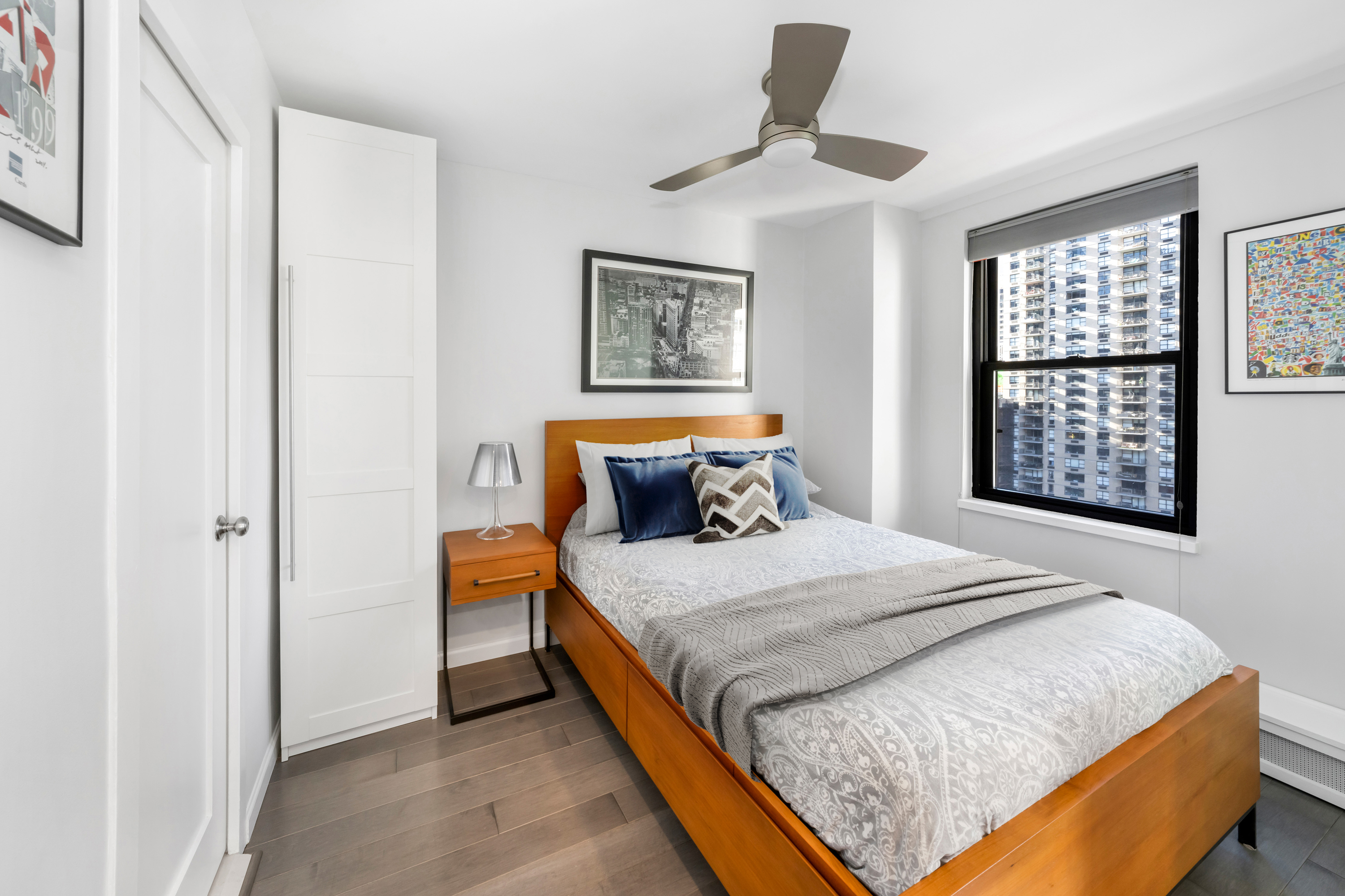 2 Tudor City Place, Unit 9OS Manhattan, NY 10017 - Photo 4 of 11 a bedroom with a large bed and a window