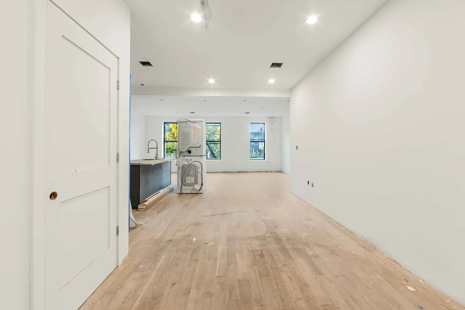 a view of a kitchen with large windows