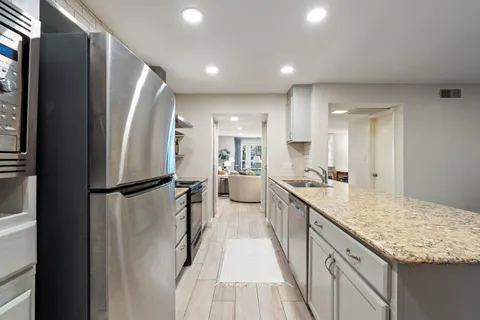 a kitchen with a stove and a refrigerator