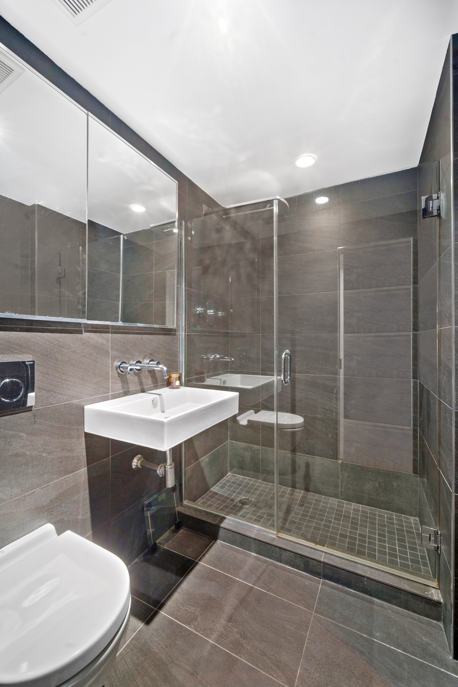 158 East 22nd Street, Unit 4 Manhattan, NY 10010 - Photo 11 of 15 a bathroom with a sink toilet and shower