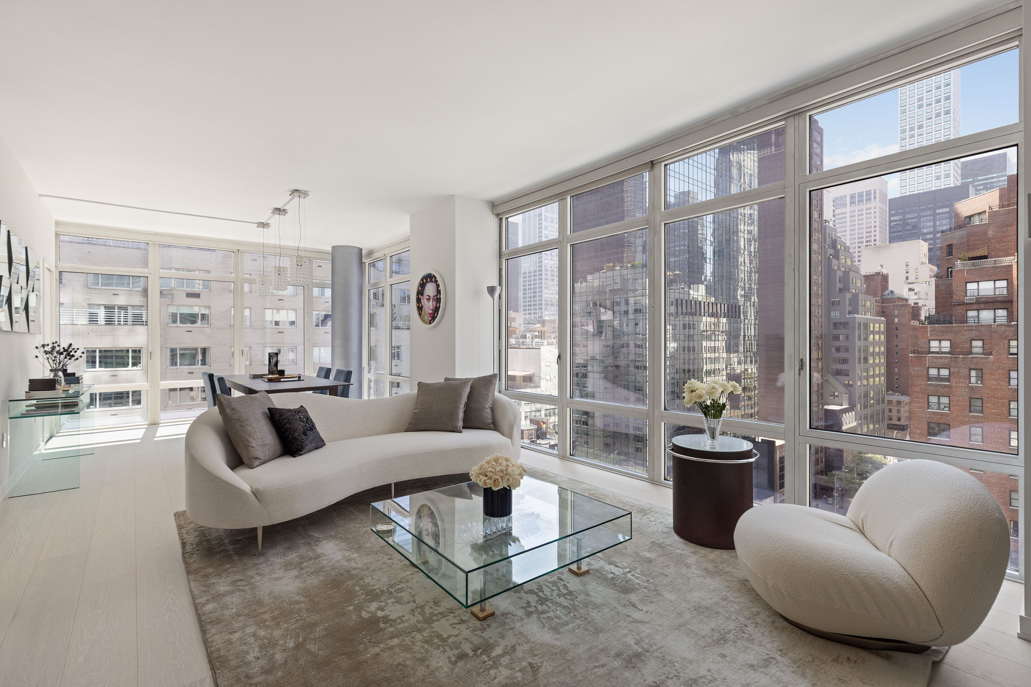 207 East 57th Street, Unit 14B Manhattan, NY 10022 - Photo 1 of 8 a living room with furniture and a large window
