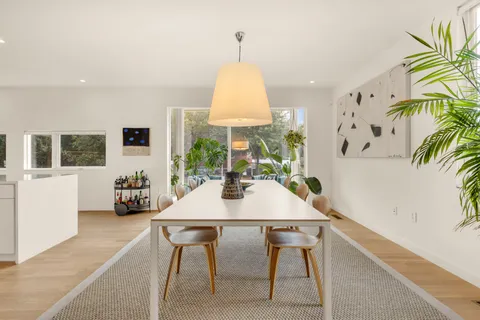 a view of a dining room with furniture and window