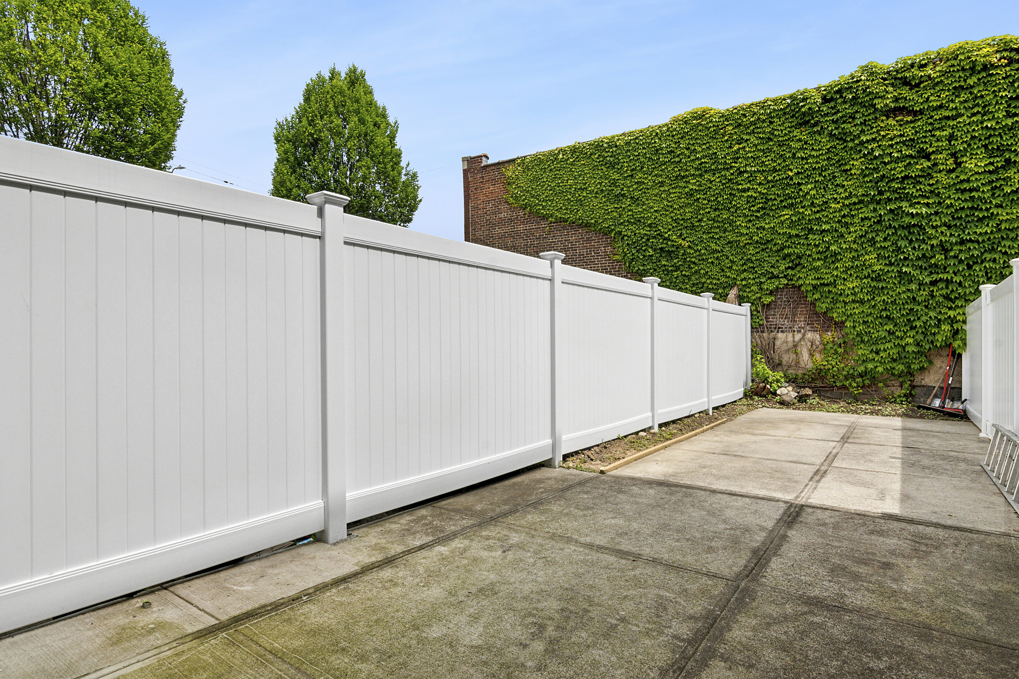 41-05 20th Avenue Queens, NY 11105 - Photo 19 of 20 a backyard of a house with plants and trees