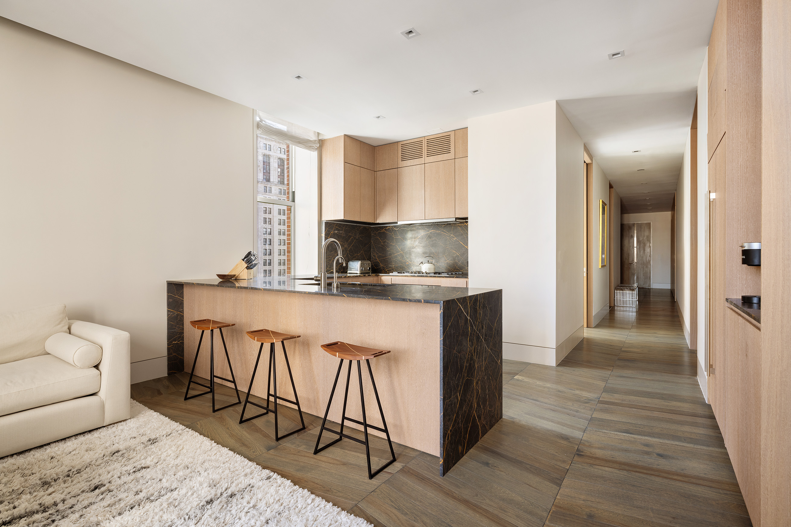 49 Chambers Street, Unit 17H Manhattan, NY 10007 - Photo 4 of 25 a kitchen with stainless steel appliances granite countertop a sink and a refrigerator