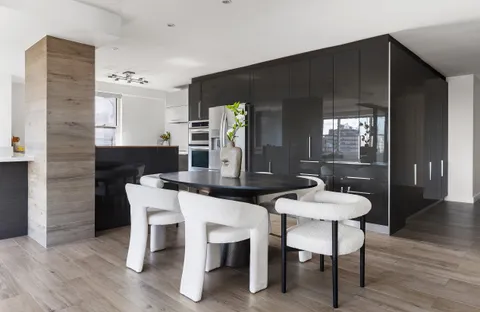 a view of a dining room with furniture and wooden floor