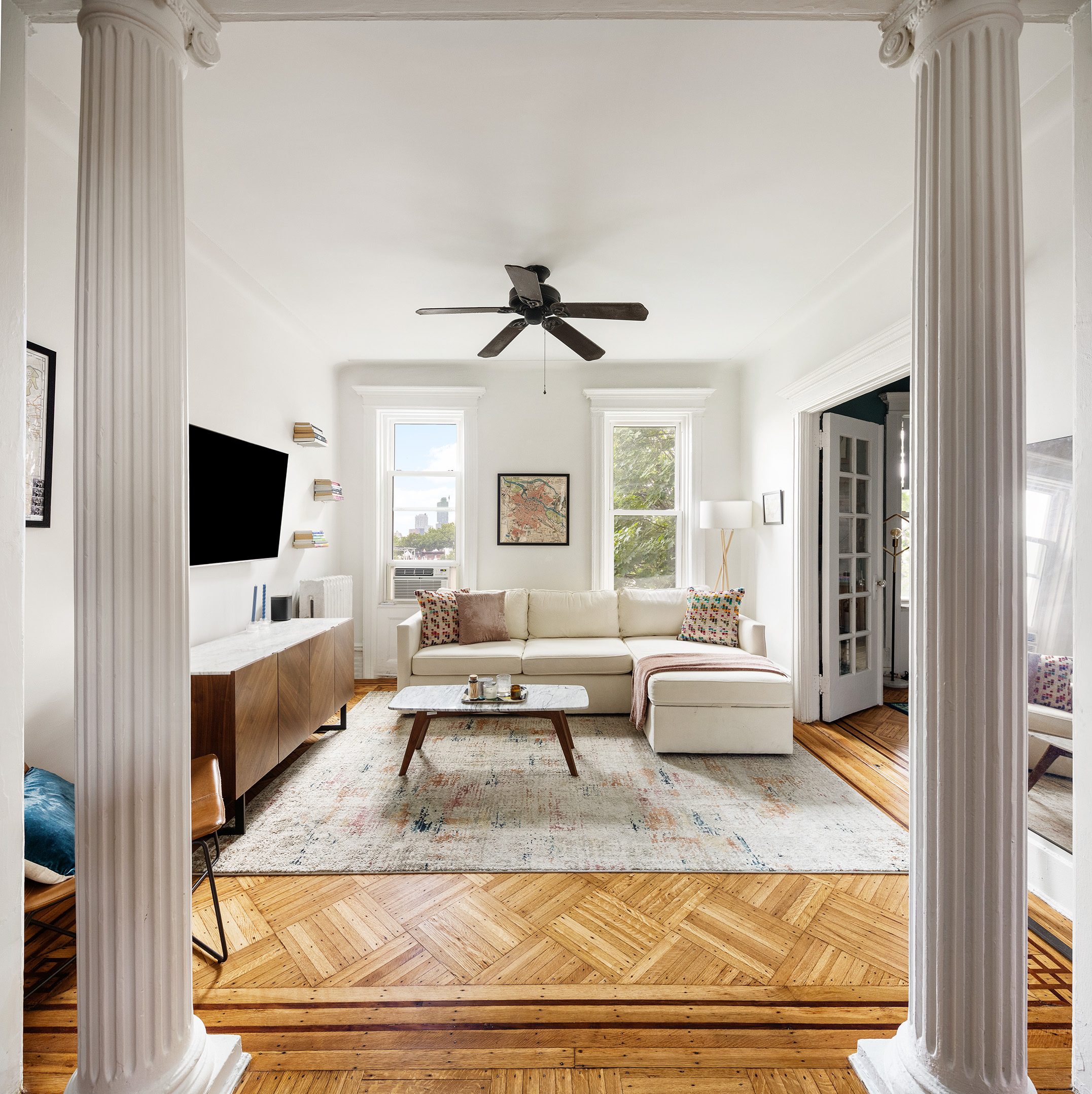 415 9th Street, Unit 53 Brooklyn, NY 11215 - Photo 1 of 5 a living room with a flat screen tv and a floor to ceiling window