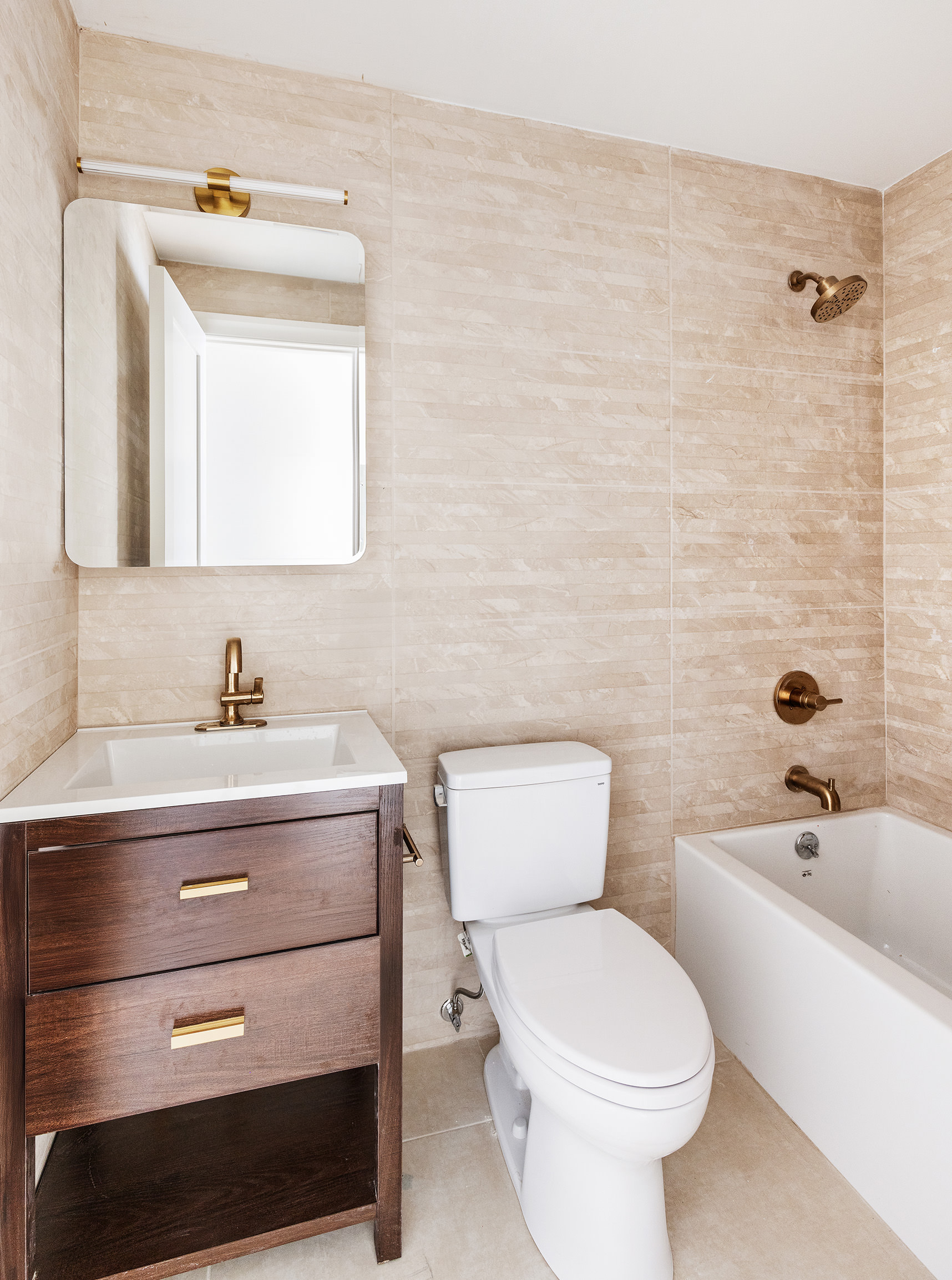 80 7th Avenue, Unit 4 Brooklyn, NY 11217 - Photo 5 of 9 a bathroom with a sink a toilet and shower