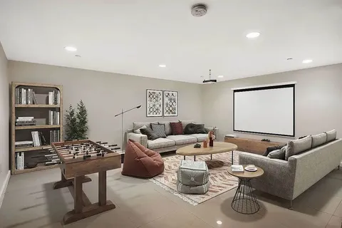a living room with furniture a rug and white walls