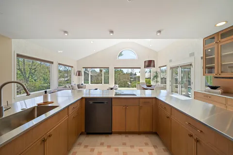 a kitchen with stainless steel appliances granite countertop a stove and a refrigerator