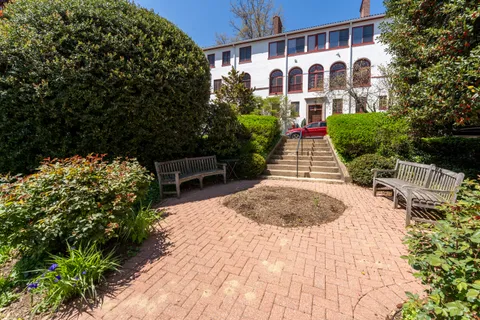 a front view of a house with garden