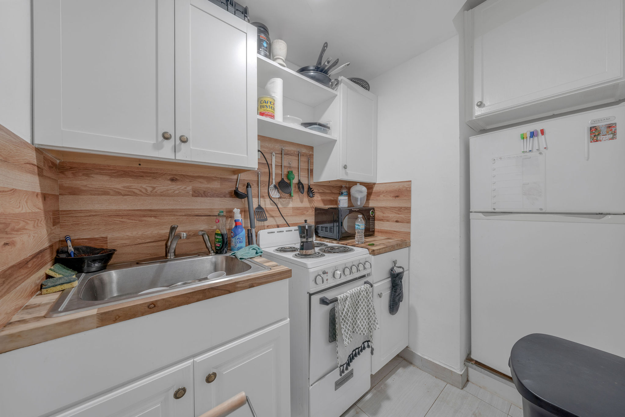 735-745 Meridian Avenue Miami Beach, FL 33139 - Photo 24 of 62 a kitchen with stainless steel appliances granite countertop a sink stove and refrigerator