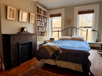 a bedroom with a bed and a fireplace