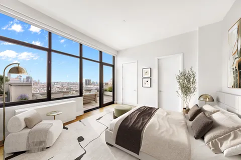 a bedroom with a large bed and a large window