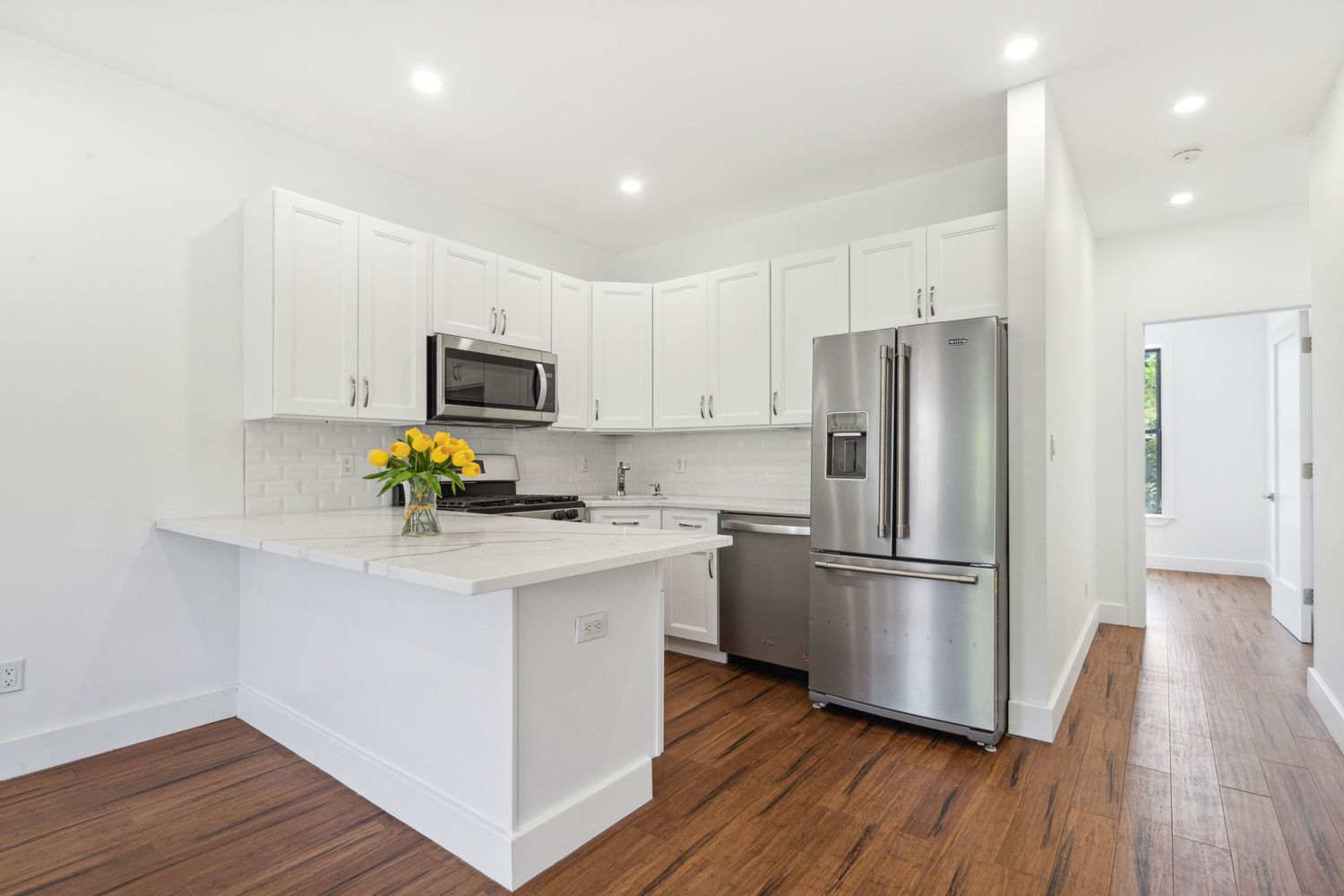 692 Putnam Avenue, Unit 2 Brooklyn, NY 11221 - Photo 1 of 15 a kitchen with a refrigerator a stove cabinets and wooden floor