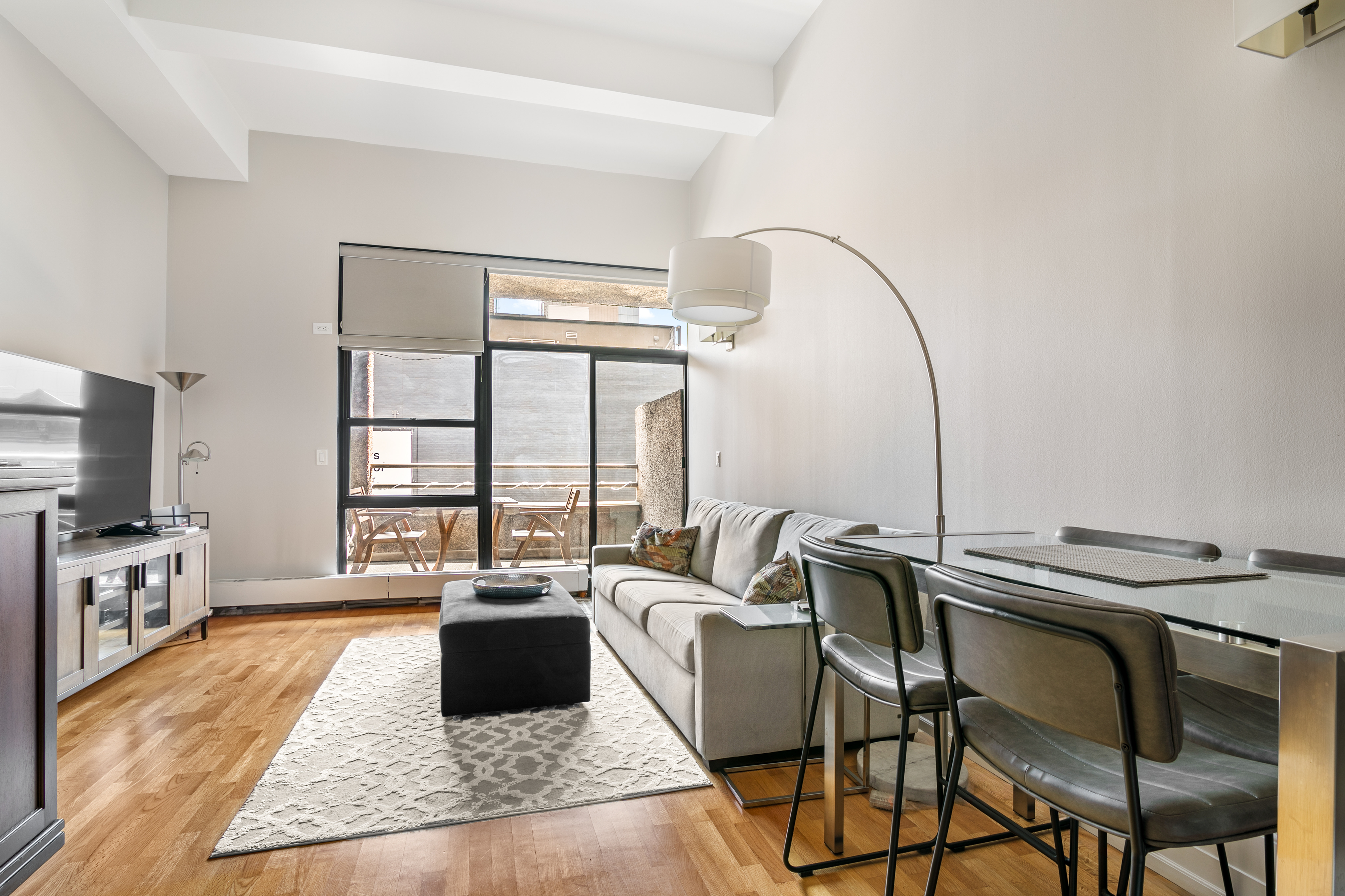 350 East 62nd Street, Unit 4B Manhattan, NY 10065 - Photo 3 of 9 a living room with furniture and a flat screen tv