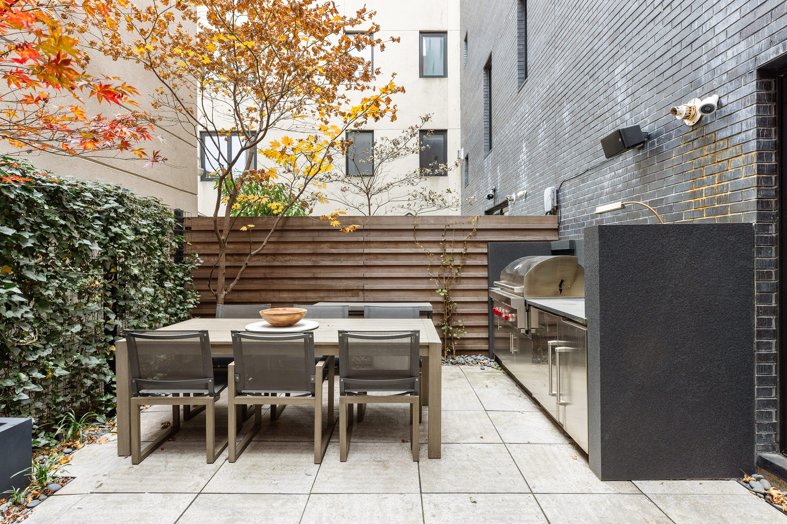 43 Dean Street Brooklyn, NY 11201 - Photo 16 of 17 a patio with a table and chairs and potted plants