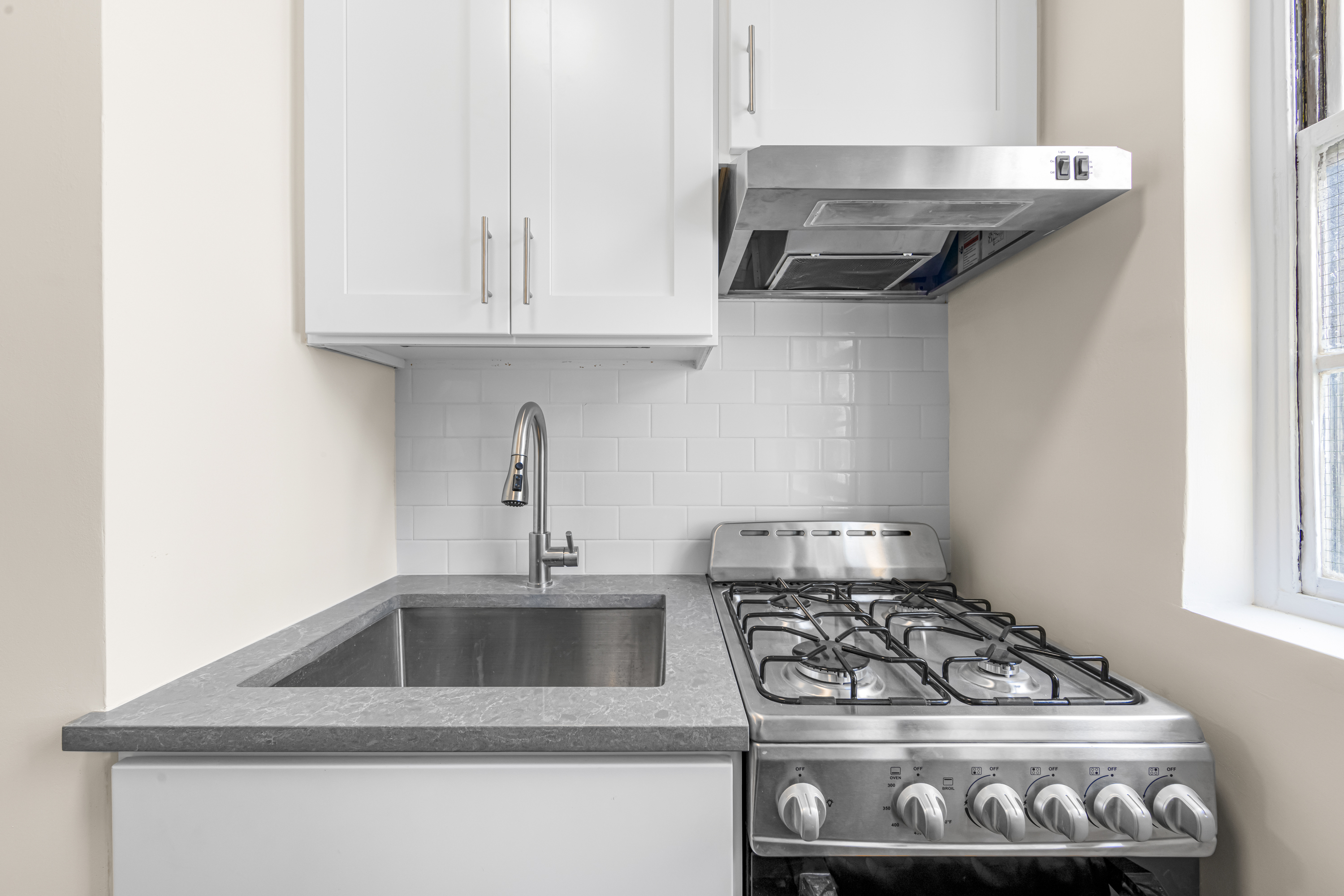 150 East 37th Street, Unit 10F Manhattan, NY 10016 - Photo 10 of 20 a kitchen with granite countertop a stove and a sink