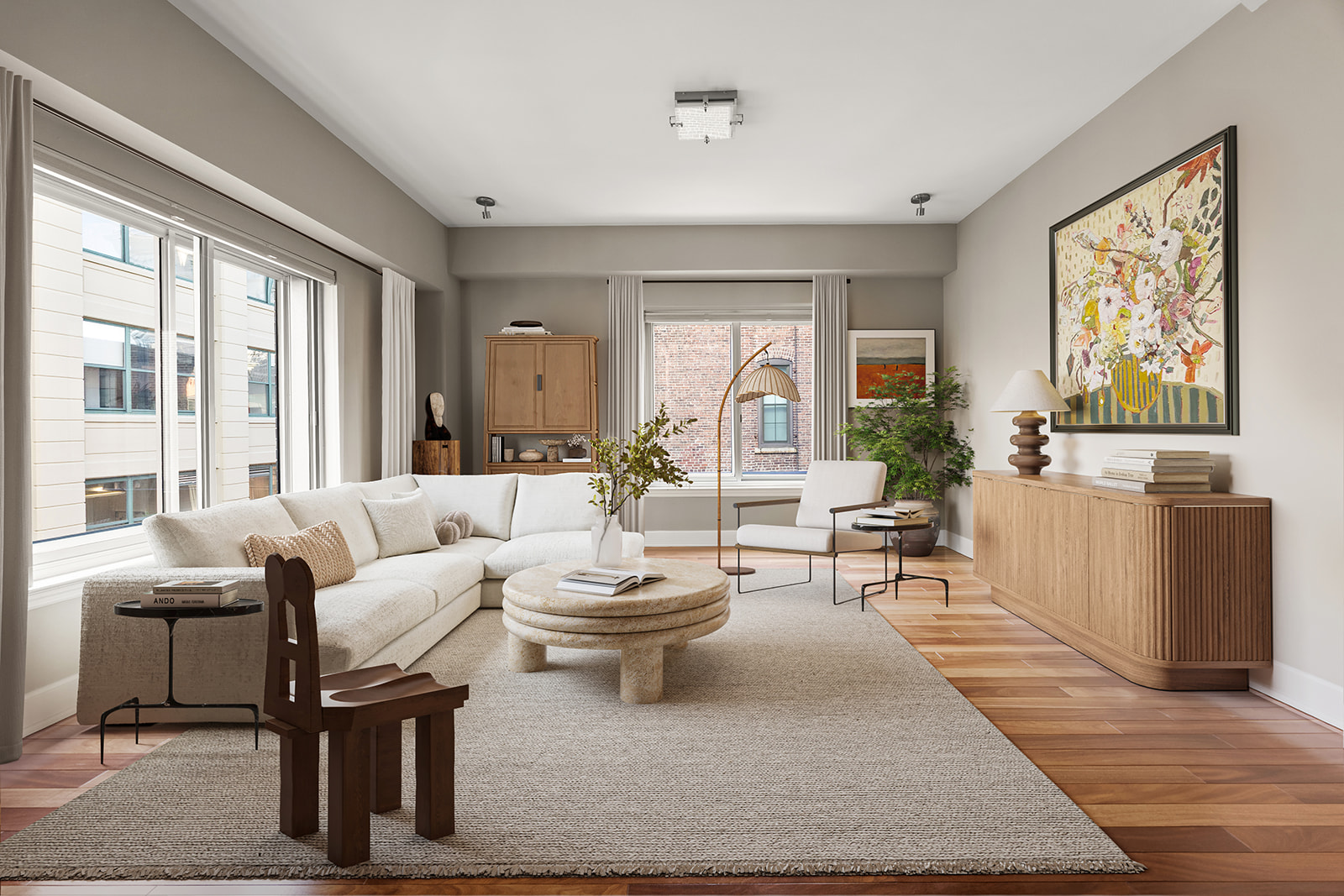 a living room with furniture a large window and wooden floor