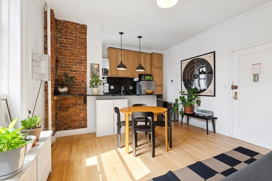 a living room with furniture a rug and white walls