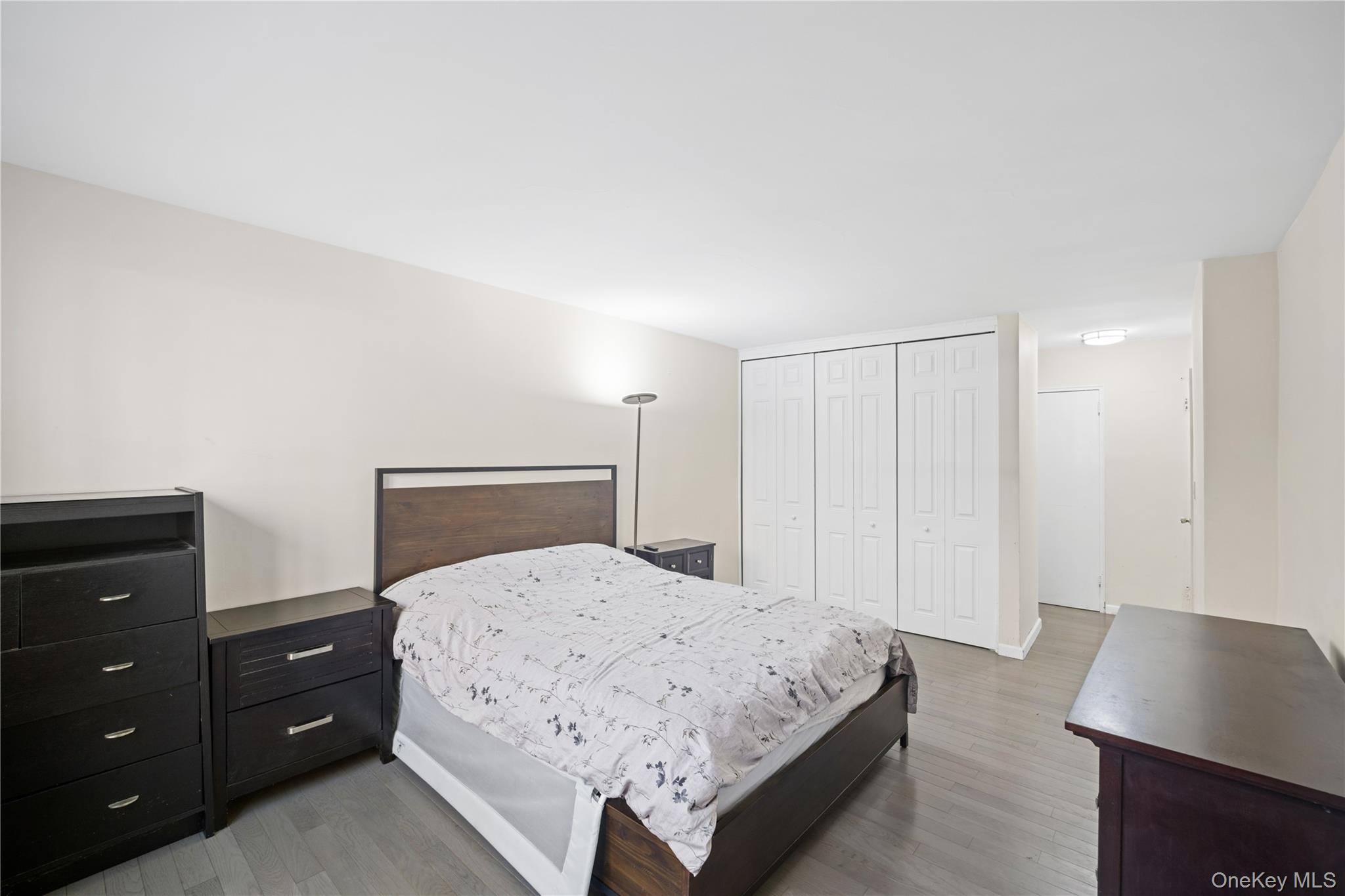 75-34 Bell Boulevard, Unit LD Queens, NY 11364 - Photo 19 of 26 a bedroom with a bed and a desk
