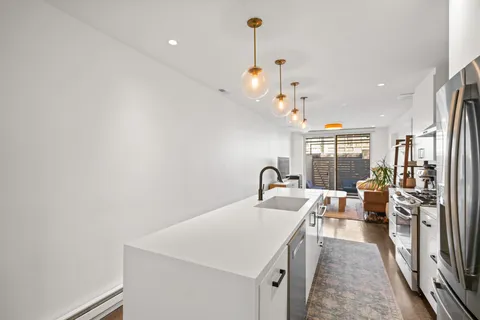 a kitchen with a sink appliances and a counter top space