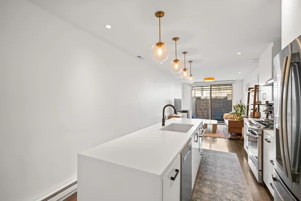 a kitchen with a sink appliances and a counter top space