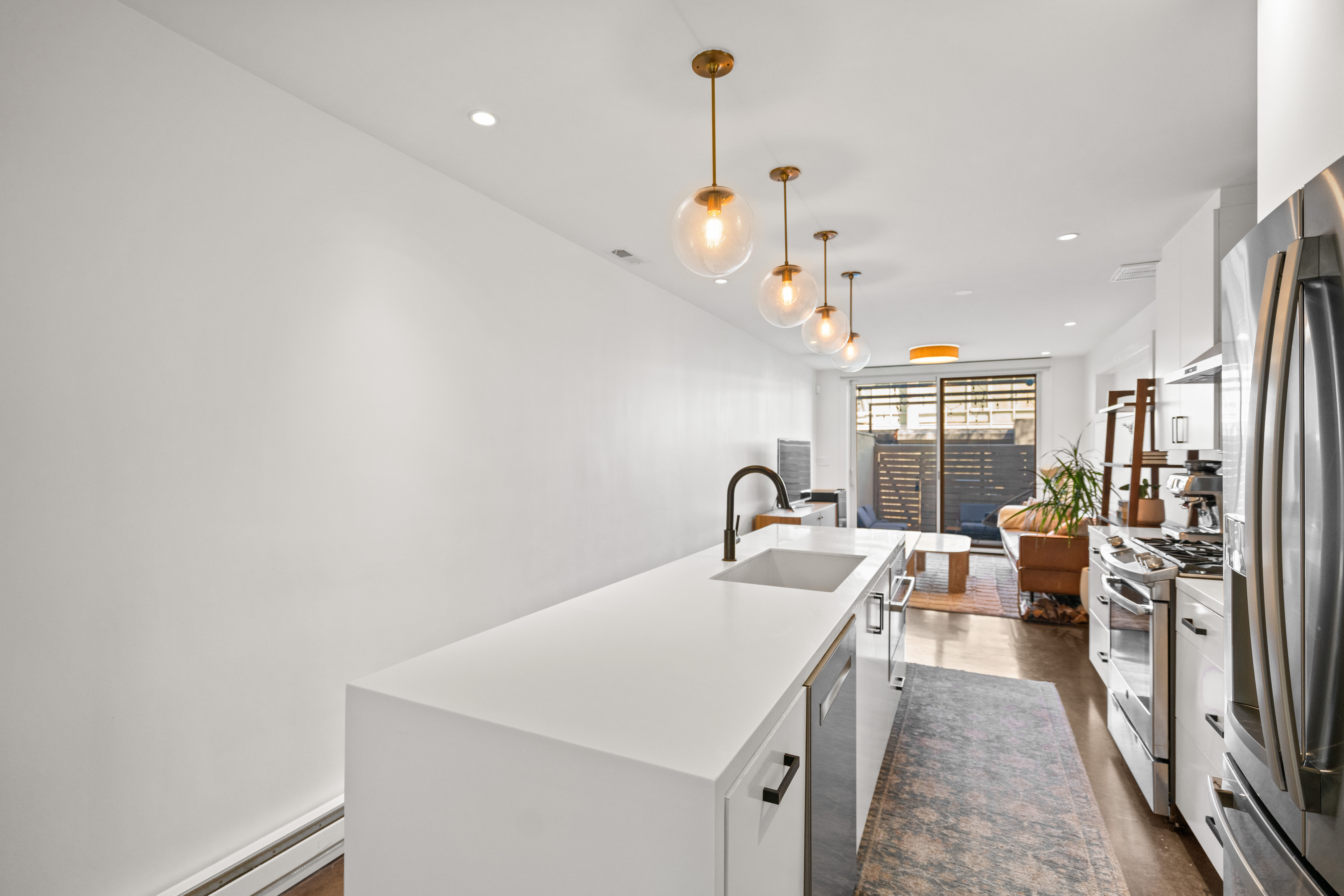 445 Ridge Street Northwest Washington, DC 20001 - Photo 10 of 43 a kitchen with a sink appliances and a counter top space