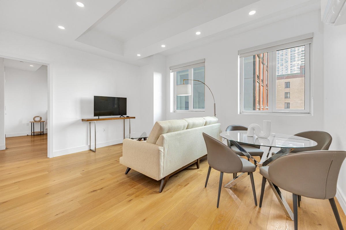 a living room with furniture and flat screen tv