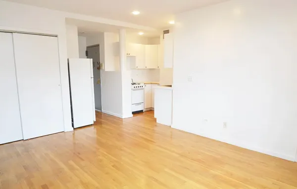 a view of a kitchen with a refrigerator and a sink