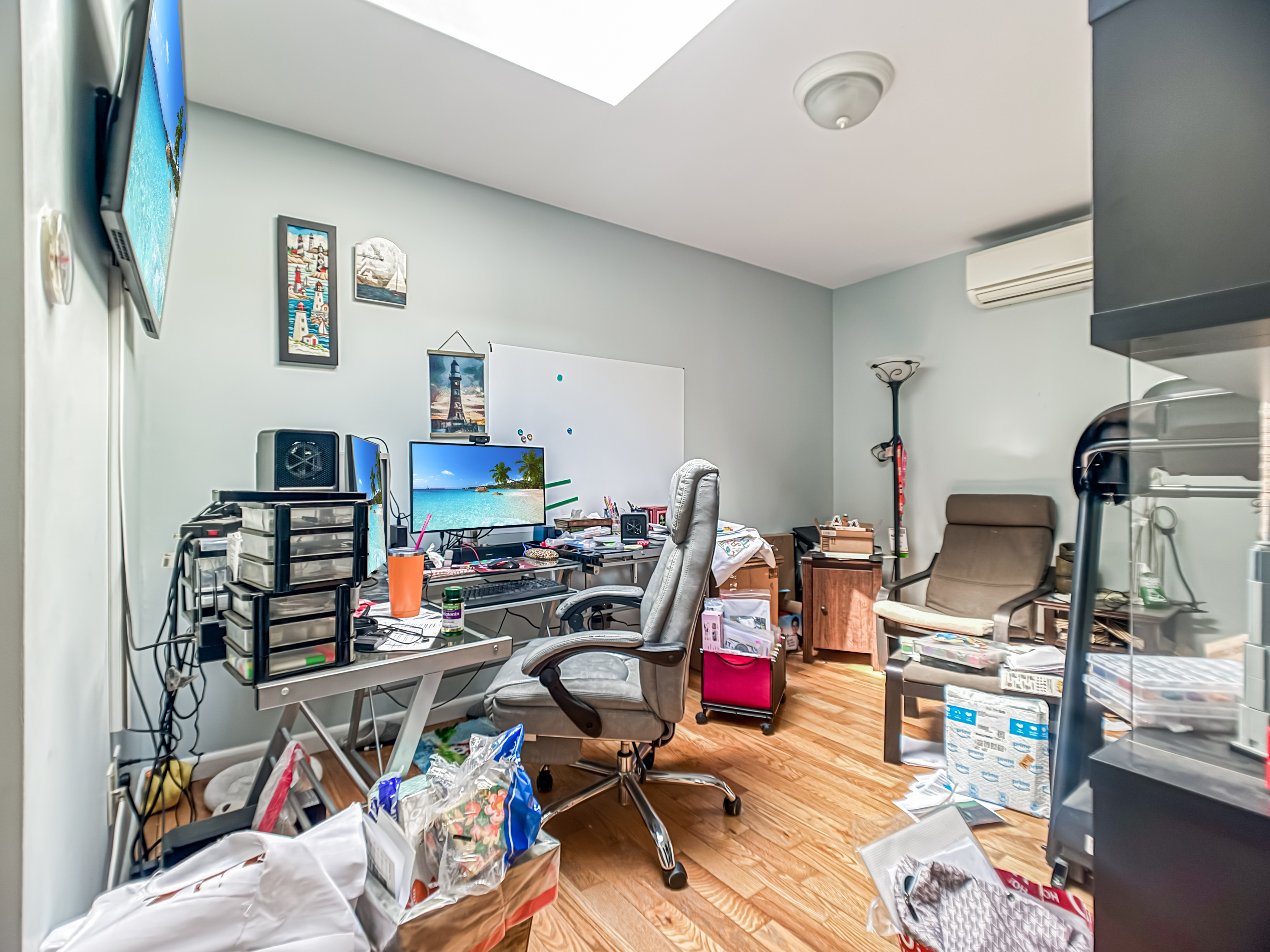 3827 28th Street Queens, NY 11101 - Photo 8 of 13 a view of a workspace with furniture and clutter