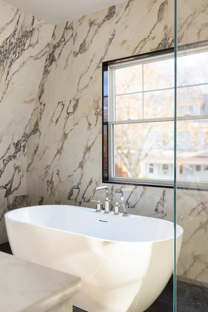 a bathroom with a bathtub and window