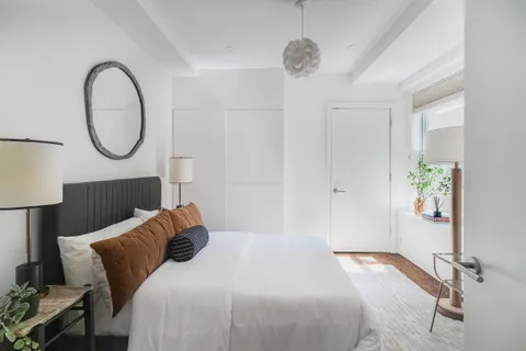 a bedroom with a bed and a chandelier