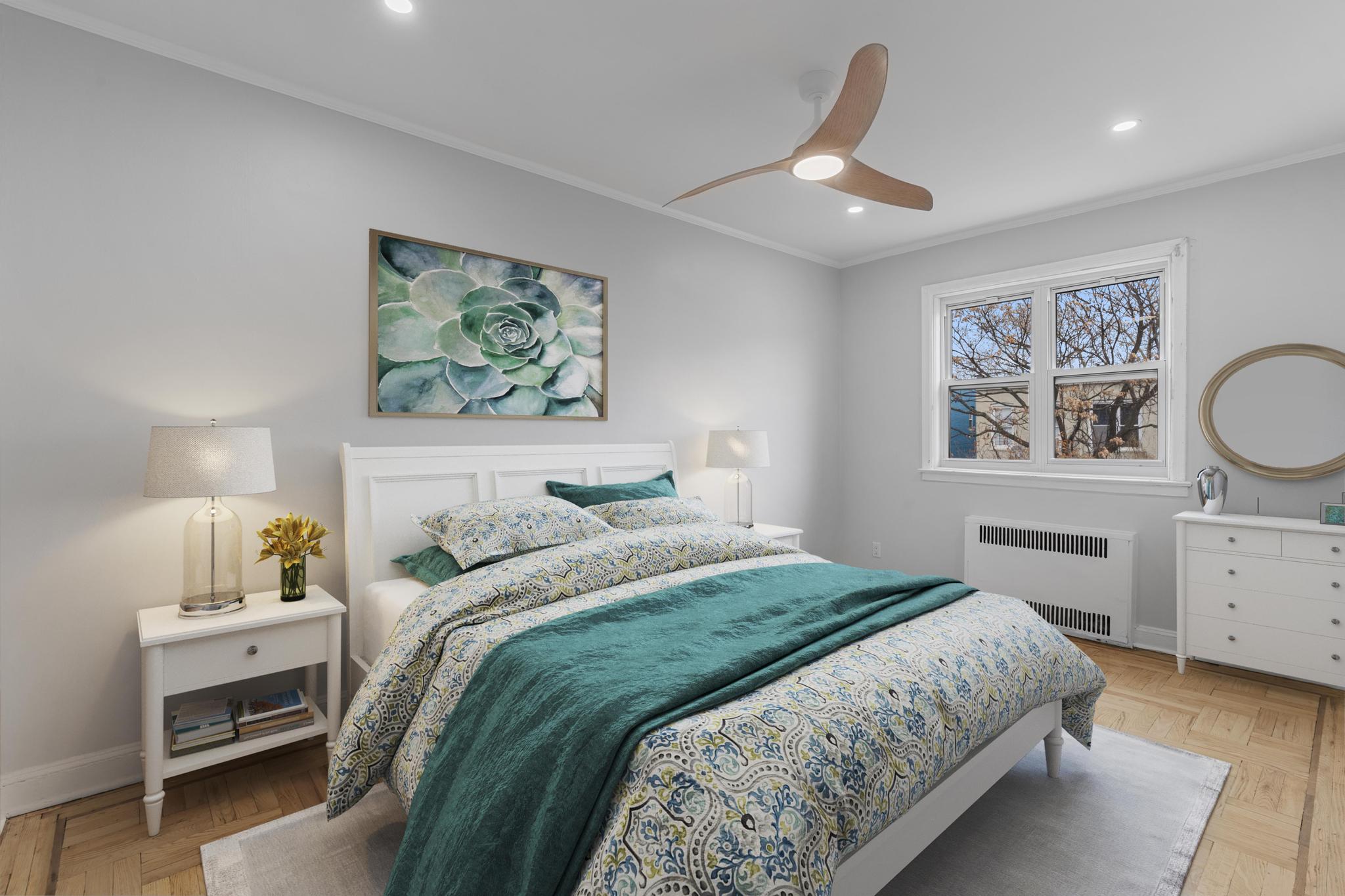 237 Remsen Avenue, Unit 1 Brooklyn, NY 11212 - Photo 8 of 16 a bedroom with a large bed and a chandelier