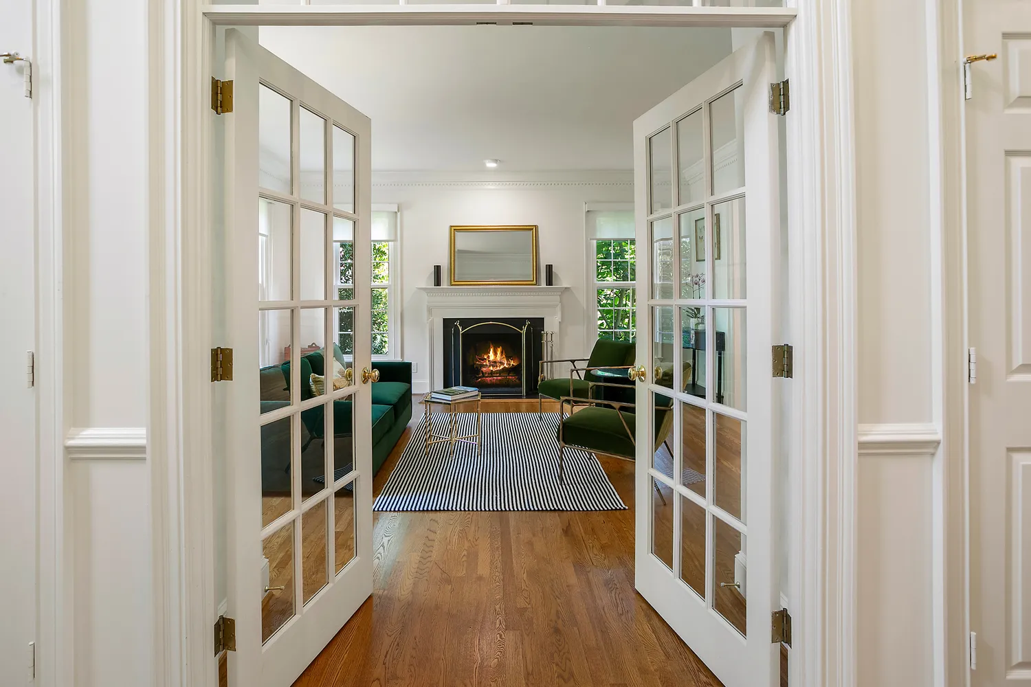 a view of a livingroom with wooden floor and fireplace