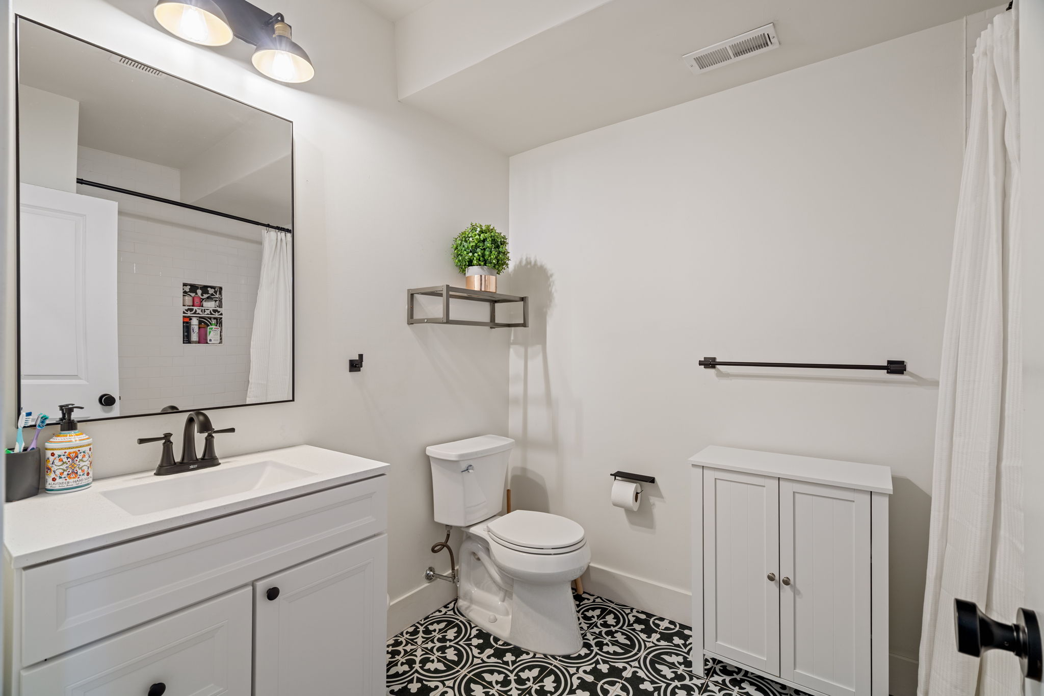 1934 Pemberton Street Philadelphia, PA 19146 - Photo 27 of 50 a bathroom with a toilet a sink and mirror