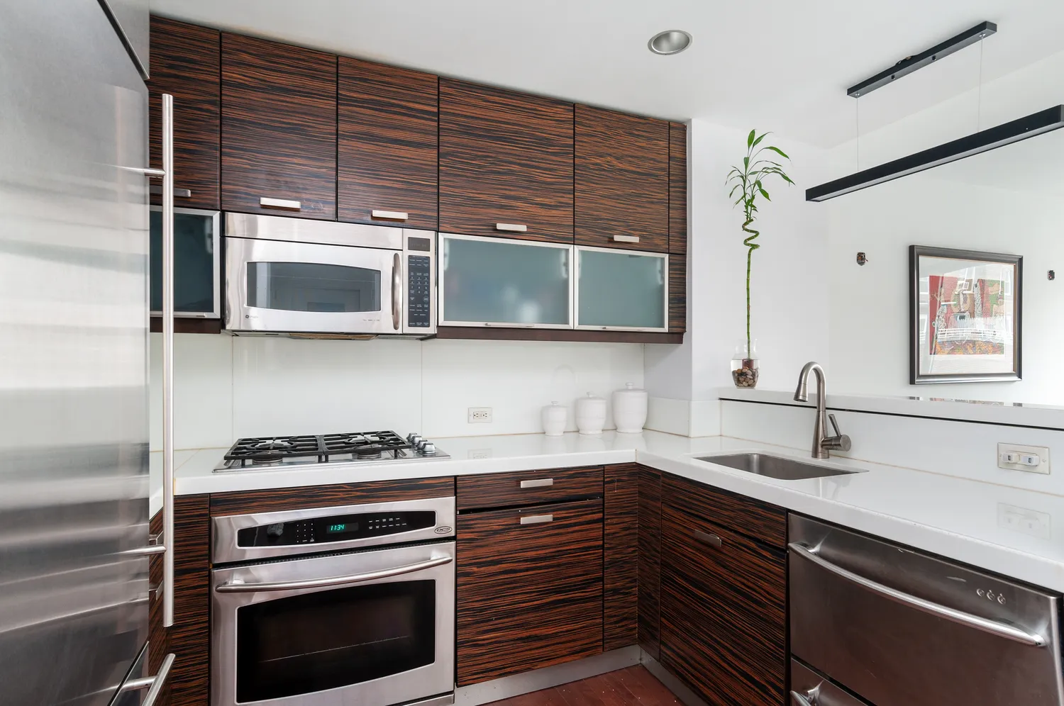 a kitchen with stainless steel appliances a stove and a microwave