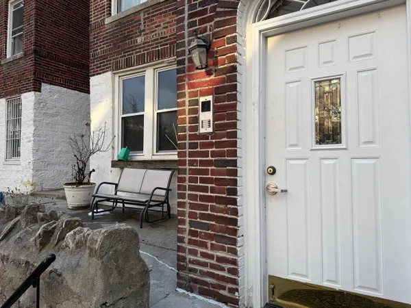 a front view of a house with outdoor seating