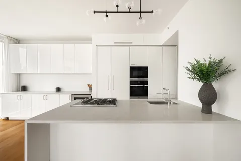 a kitchen with kitchen island a stove a sink and a refrigerator