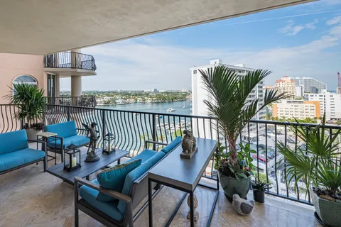 a view of a balcony with furniture and a potted plant