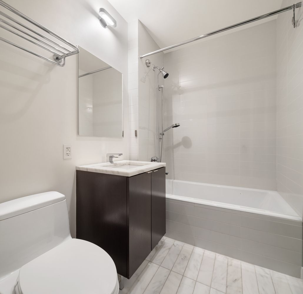 101 Warren Street, Unit 11L Manhattan, NY 10007 - Photo 14 of 26 a bathroom with a sink a toilet and shower