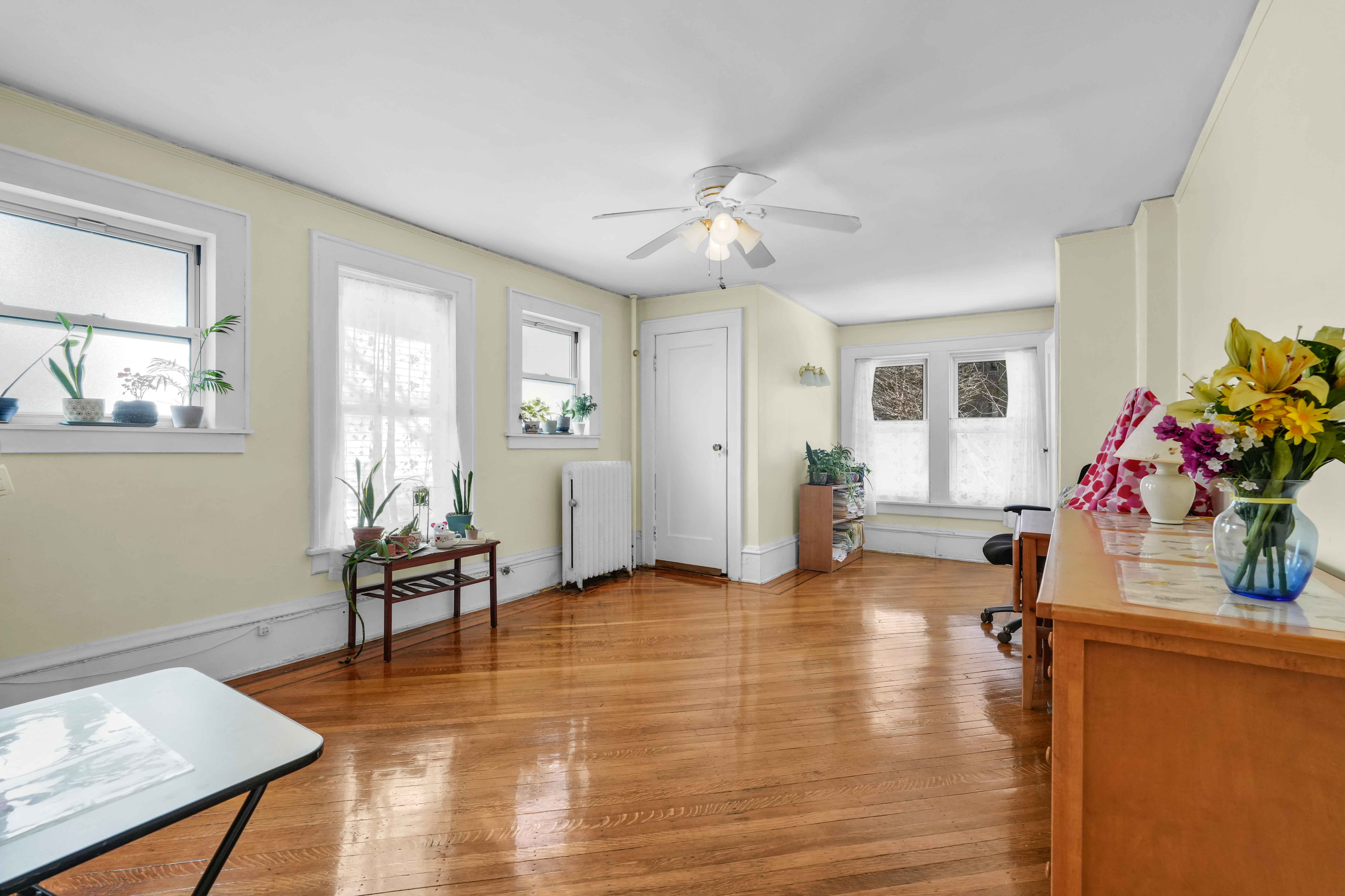 642 East 26th Street Brooklyn, NY 11210 - Photo 14 of 32 a view of a livingroom with wooden floor and a chandelier
